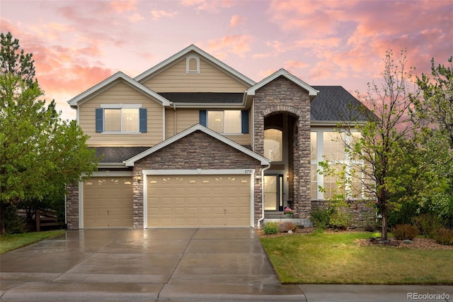 view of front facade with stone siding, concrete driveway, a front lawn, a shingled roof, and an attached garage