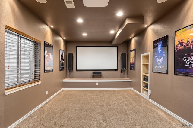 cinema room with carpet flooring, recessed lighting, baseboards, and built in shelves