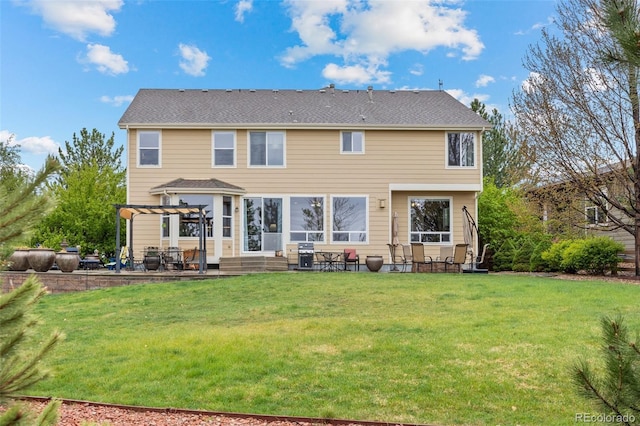rear view of property with a pergola, a patio area, and a yard