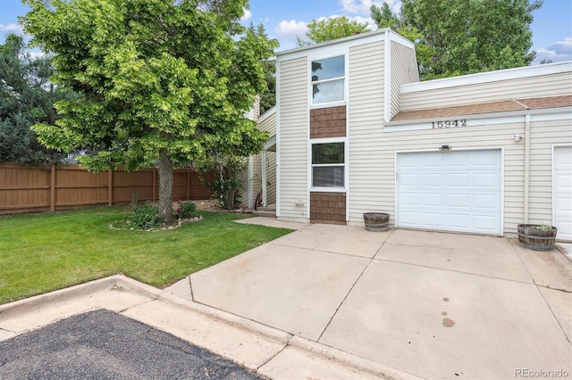 15942 E Rice Pl Unit B, Aurora, CO 80015 - view of front of home featuring driveway, a garage, and roof with shingles
