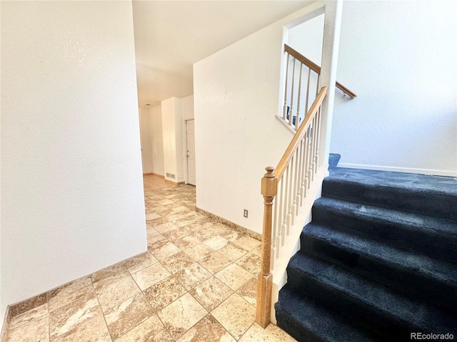 2247 Coronado Pkwy N # D, Denver, CO 80229 - stairs featuring stone tile flooring and baseboards