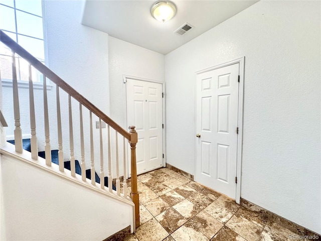 2247 Coronado Pkwy N # D, Denver, CO 80229 - entryway with stone finish flooring, stairway, and a textured wall