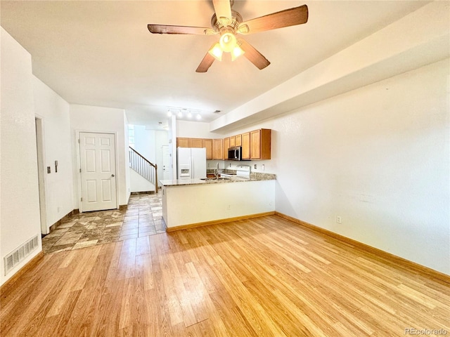 2247 Coronado Pkwy N # D, Denver, CO 80229 - unfurnished living room featuring light wood-type flooring, ceiling fan, and baseboards