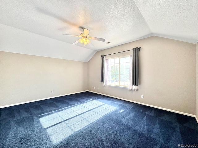 2247 Coronado Pkwy N # D, Denver, CO 80229 - additional living space featuring lofted ceiling, dark carpet, a ceiling fan, baseboards, and a textured ceiling