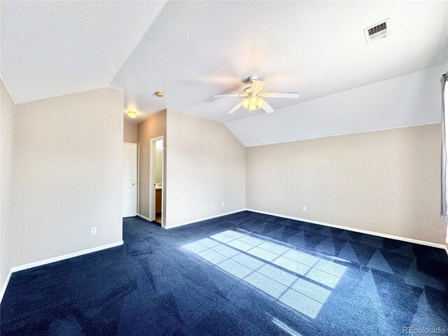 2247 Coronado Pkwy N # D, Denver, CO 80229 - bonus room featuring dark colored carpet, vaulted ceiling, ceiling fan, baseboards, and a textured ceiling