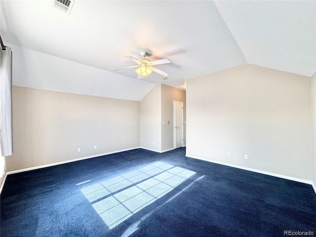 2247 Coronado Pkwy N # D, Denver, CO 80229 - additional living space with lofted ceiling, ceiling fan, baseboards, dark colored carpet, and a textured ceiling