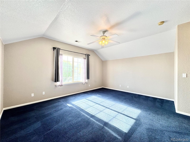 2247 Coronado Pkwy N # D, Denver, CO 80229 - additional living space featuring vaulted ceiling, dark colored carpet, baseboards, a ceiling fan, and a textured ceiling