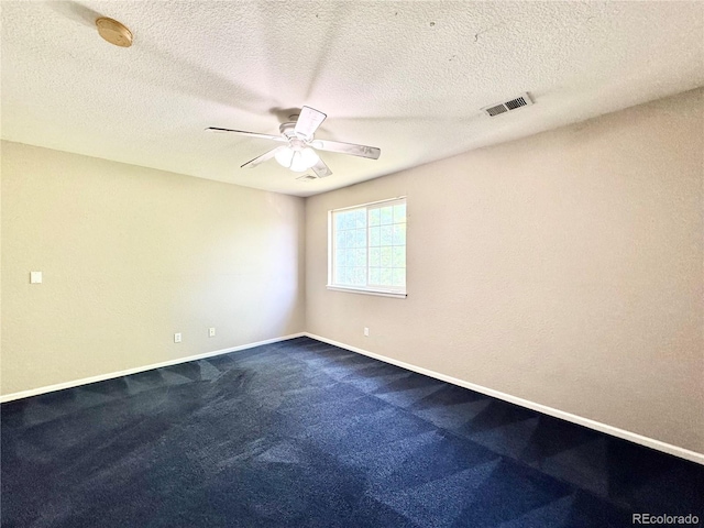 2247 Coronado Pkwy N # D, Denver, CO 80229 - empty room with ceiling fan, dark carpet, baseboards, a smoke detector, and a textured ceiling