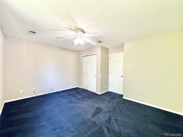 2247 Coronado Pkwy N # D, Denver, CO 80229 - unfurnished bedroom with baseboards, dark carpet, ceiling fan, and a closet