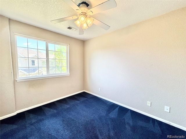 2247 Coronado Pkwy N # D, Denver, CO 80229 - unfurnished room with dark carpet, a ceiling fan, baseboards, and a textured ceiling