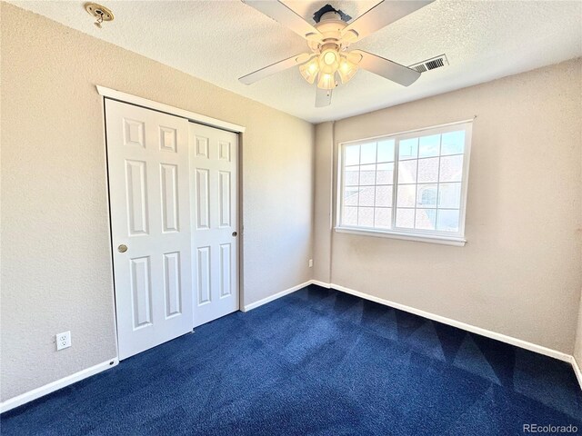 2247 Coronado Pkwy N # D, Denver, CO 80229 - unfurnished bedroom featuring dark colored carpet, a closet, ceiling fan, baseboards, and a textured ceiling