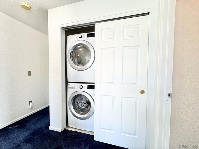 2247 Coronado Pkwy N # D, Denver, CO 80229 - laundry room with estacked washer and dryer, dark colored carpet, and baseboards