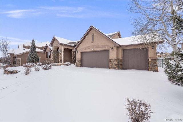 view of front facade featuring a garage, stone siding, and stucco siding