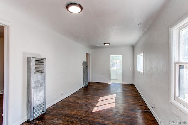 unfurnished room featuring dark wood-type flooring