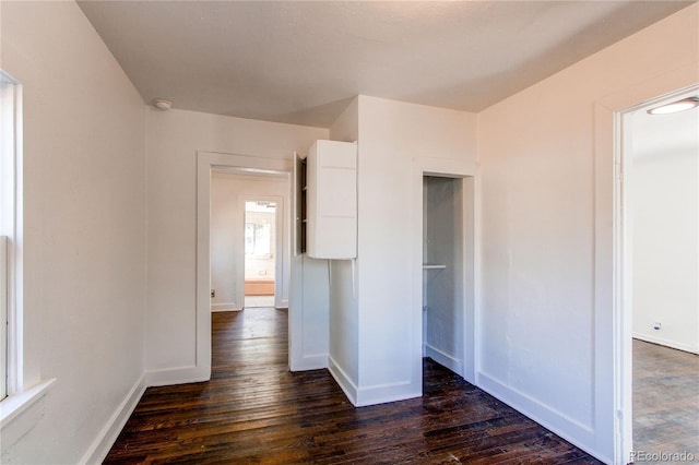 unfurnished bedroom with dark hardwood / wood-style floors