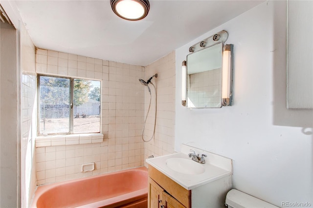 full bathroom with vanity, tiled shower / bath combo, and toilet