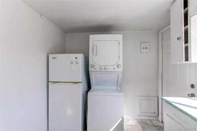 laundry room with stacked washer and dryer