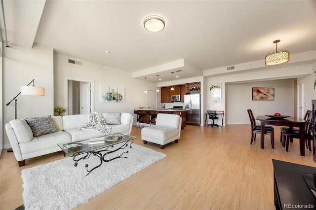 living room with light hardwood / wood-style flooring