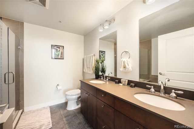 bathroom featuring tile patterned floors, vanity, toilet, and walk in shower