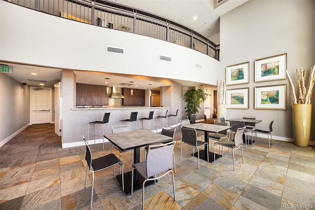 dining space with a towering ceiling