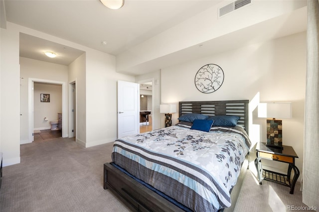 carpeted bedroom featuring ensuite bathroom