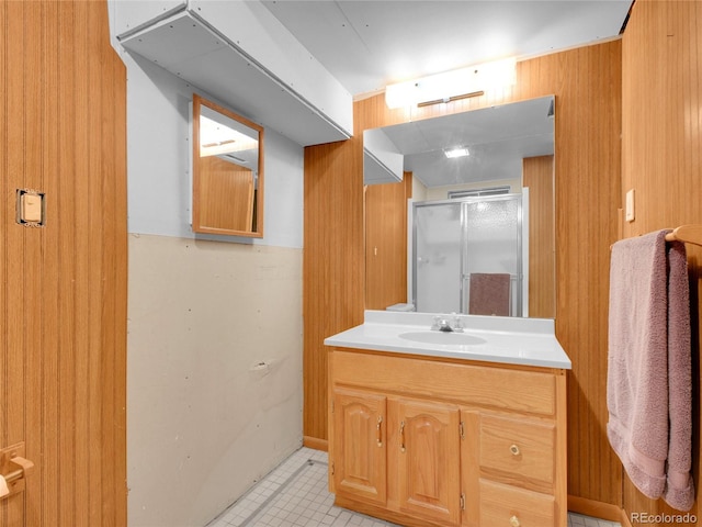 13133 Regulus Dr, Lone Tree, CO 80124 - full bathroom featuring a stall shower, tile patterned flooring, vanity, and wooden walls