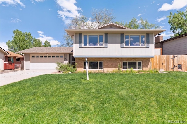 3298 Quail St, Wheat Ridge, CO 80033 - tri-level home featuring an attached garage, concrete driveway, and brick siding