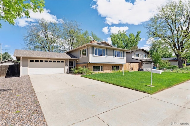 3298 Quail St, Wheat Ridge, CO 80033 - tri-level home featuring concrete driveway and an attached garage