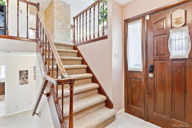 3298 Quail St, Wheat Ridge, CO 80033 - tiled entryway with stairs, baseboards, and plenty of natural light