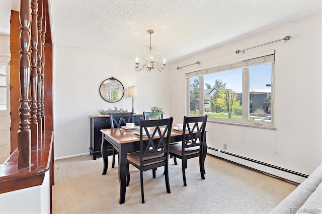 3298 Quail St, Wheat Ridge, CO 80033 - dining space featuring a baseboard radiator, a chandelier, light carpet, a textured ceiling, and baseboards