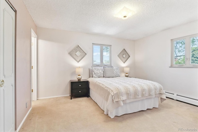 3298 Quail St, Wheat Ridge, CO 80033 - bedroom featuring light carpet, a textured ceiling, a baseboard radiator, and baseboards
