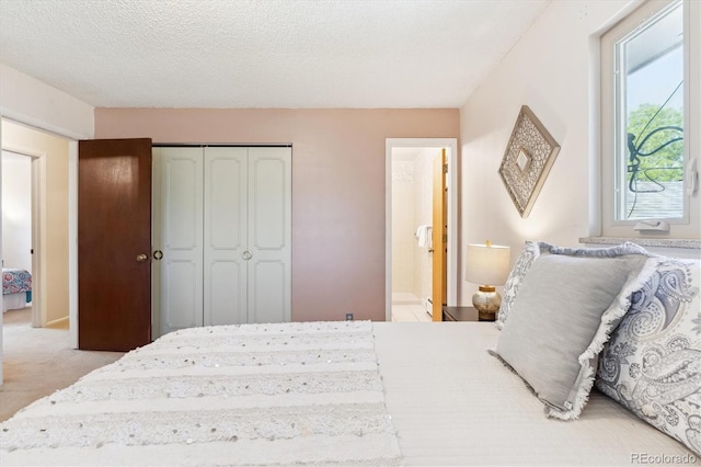 3298 Quail St, Wheat Ridge, CO 80033 - bedroom featuring multiple windows, light carpet, a closet, ensuite bath, and a textured ceiling
