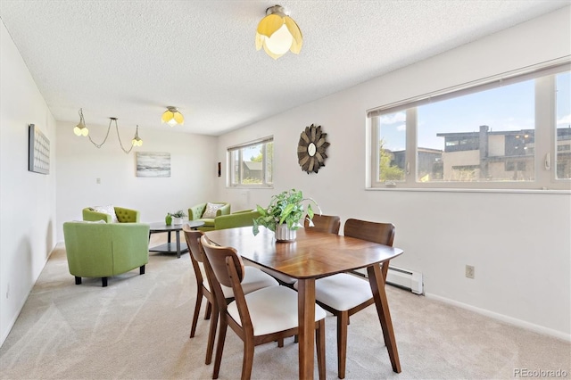 3298 Quail St, Wheat Ridge, CO 80033 - dining space with light carpet, a textured ceiling, and baseboards