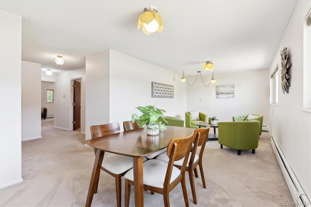 3298 Quail St, Wheat Ridge, CO 80033 - dining room with baseboard heating, light colored carpet, plenty of natural light, and a textured ceiling