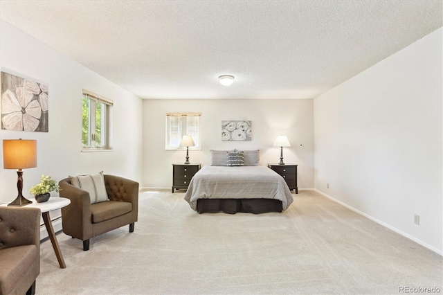 3298 Quail St, Wheat Ridge, CO 80033 - bedroom featuring a baseboard heating unit, light carpet, baseboards, and a textured ceiling