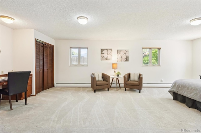 3298 Quail St, Wheat Ridge, CO 80033 - bedroom featuring a baseboard radiator, a textured ceiling, carpet floors, and multiple windows