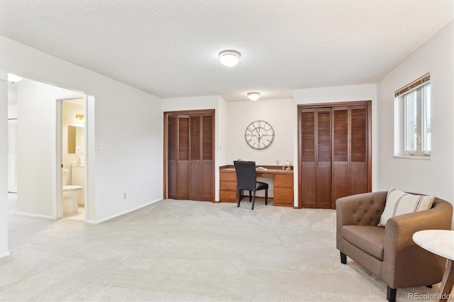 3298 Quail St, Wheat Ridge, CO 80033 - living area with an office area, light carpet, baseboards, and a textured ceiling