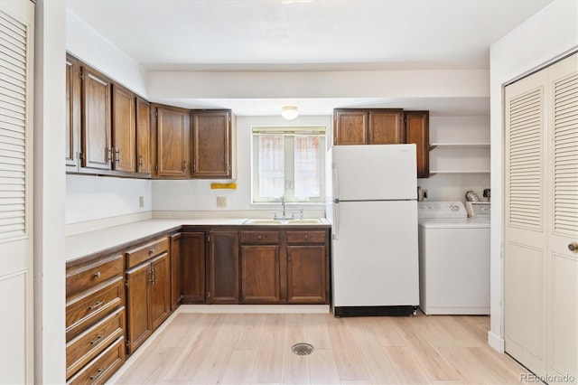 3298 Quail St, Wheat Ridge, CO 80033 - kitchen with freestanding refrigerator, a sink, independent washer and dryer, light countertops, and light wood finished floors