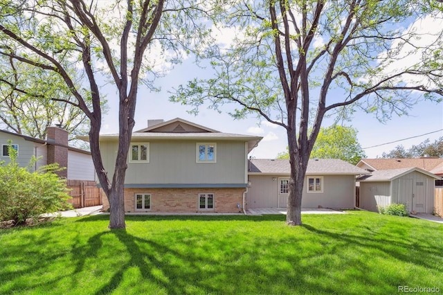 3298 Quail St, Wheat Ridge, CO 80033 - back of property with a storage unit, an outdoor structure, and brick siding