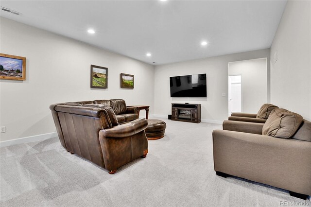 living room featuring carpet, visible vents, baseboards, and recessed lighting