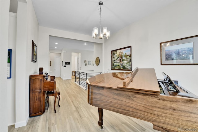 rec room with recessed lighting, light wood-style floors, baseboards, and a notable chandelier