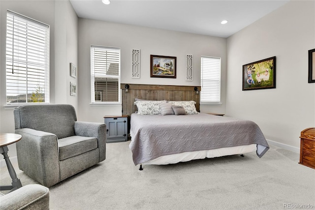carpeted bedroom featuring baseboards and recessed lighting