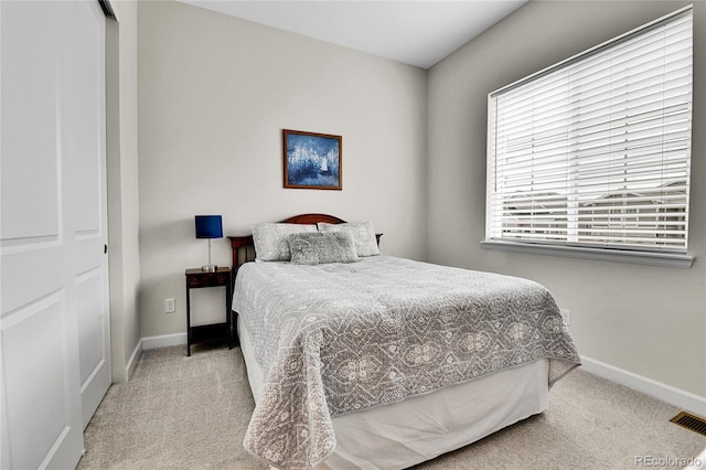 bedroom featuring carpet flooring, visible vents, and baseboards