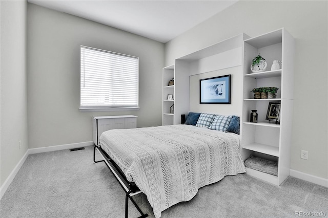 carpeted bedroom featuring radiator and baseboards