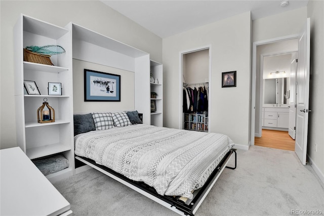 carpeted bedroom with a closet, baseboards, and a spacious closet