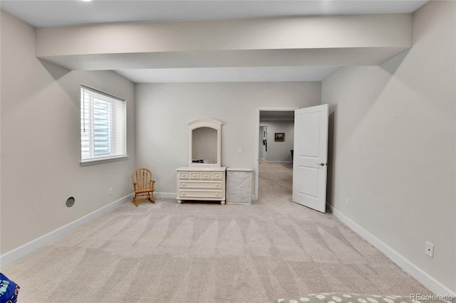 unfurnished bedroom featuring baseboards and light colored carpet