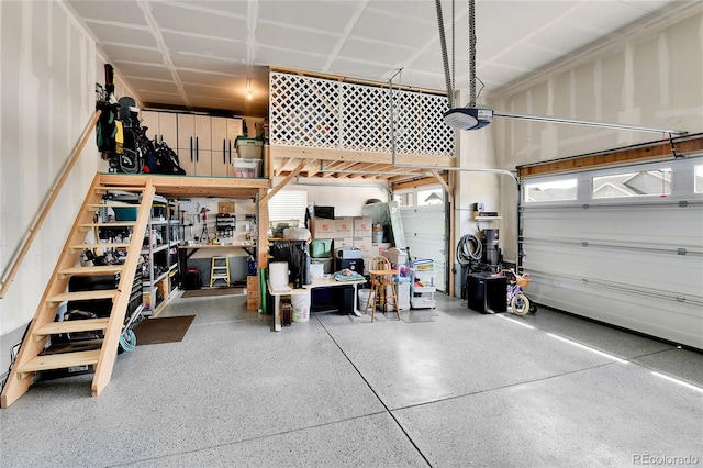 garage with a garage door opener and a workshop area