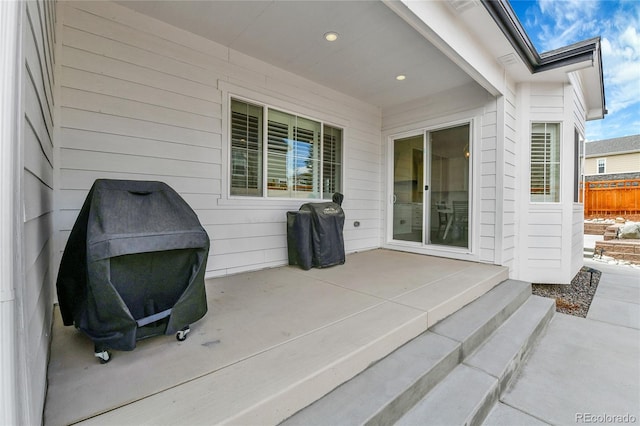 view of patio featuring grilling area and fence