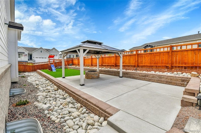 view of patio / terrace featuring a gazebo, a playground, a residential view, and a fenced backyard