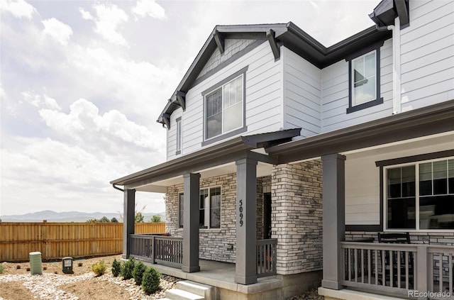 5099 S Robb St, Littleton, CO 80127 - view of side of home featuring covered porch and stone siding